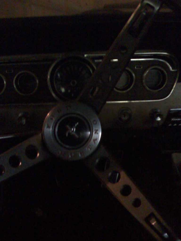 1966 Ford Mustang interior with steering wheel and dashboard gauges