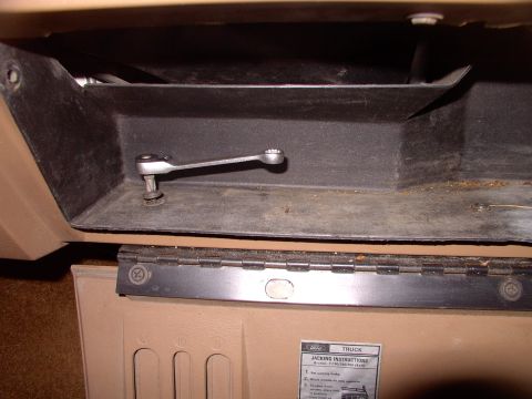 1986 Ford Bronco - Start by removing the inner glove box liner. Three screws on the bottom, like this one in the pic. Then two holding the cables on.