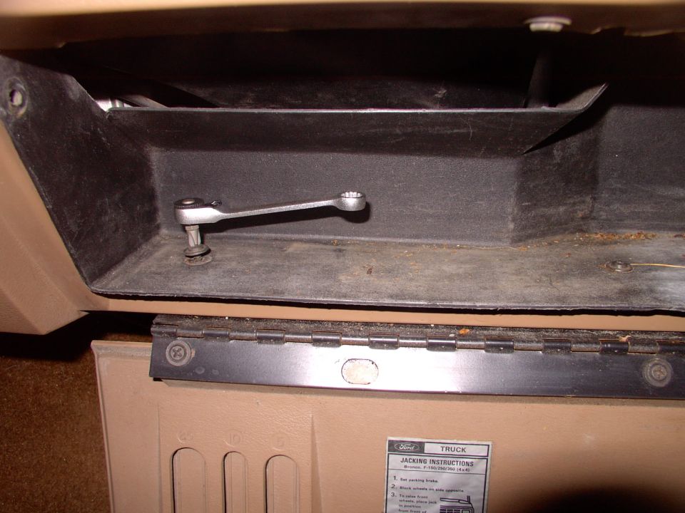 Start by removing the inner glove box liner. Three screws on the bottom, like this one in the pic. Then two holding the cables on.