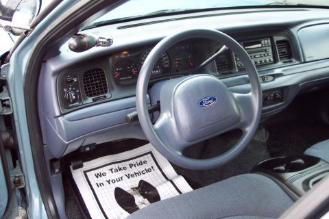 2001 Ford Crown Victoria - The interior of a 2001 Ford Crown Victoria, a floor mat that reads 'We Take Pride In Your Vehicle!'