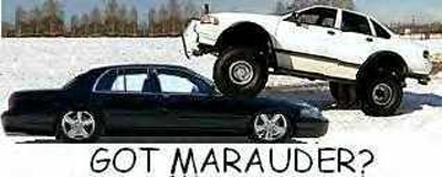 1991 Ford Crown Victoria LTD - A black sedan is parked low in the snow, while a white lifted sedan is positioned on top of it.