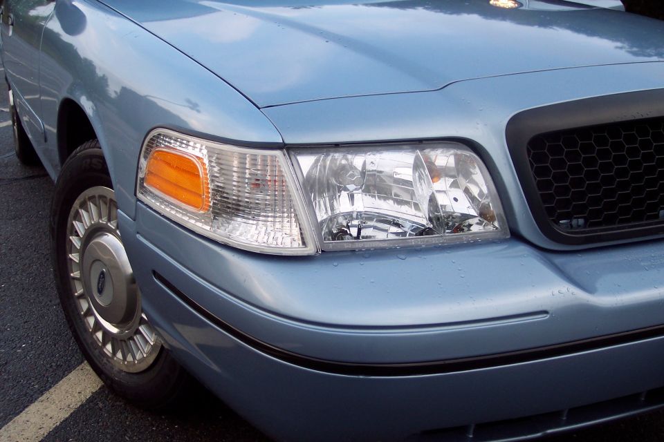 Light blue 2001 Ford Crown Victoria front passenger side headlight and fender