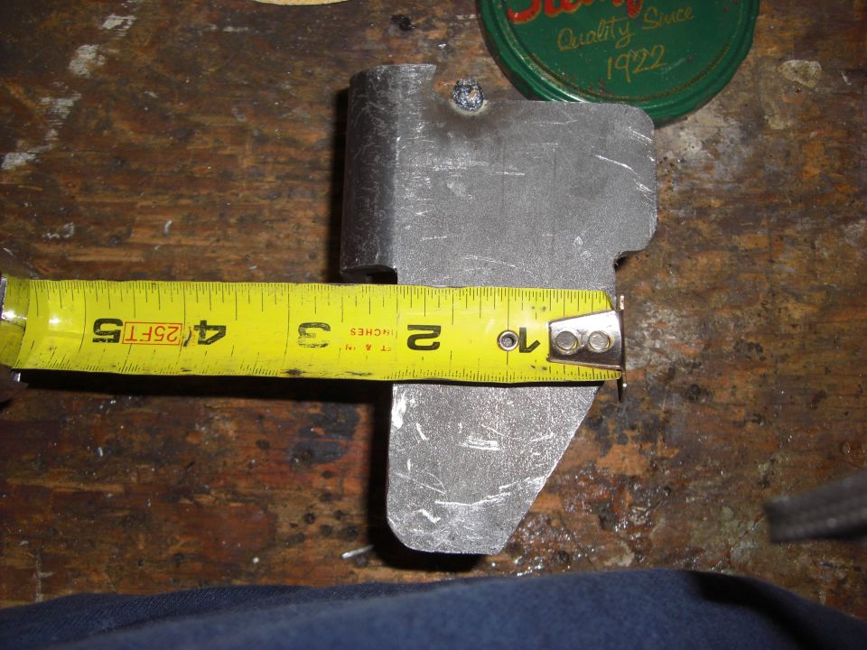 Yellow measuring tape showing 4.5 inches next to a metal part.