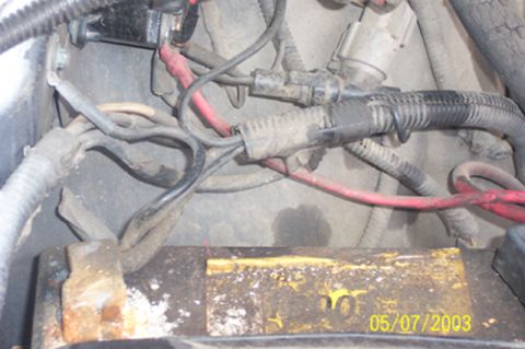 1991 Ford Crown Victoria LTD - Engine bay wiring and a corroded battery are visible in this close-up view.