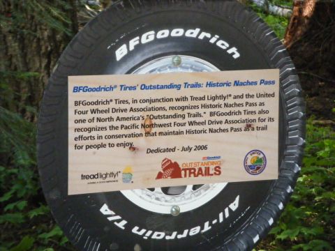 2005 Jeep Wrangler - A sign is attached to a BFGoodrich All-Terrain T/A tire, mounted on a vehicle, detailing the "Historic Naches Pass" trail. The sign thanks…