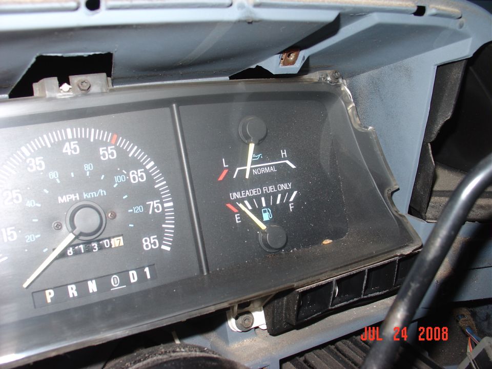 Vehicle dashboard with speedometer, odometer, and fuel gauge.