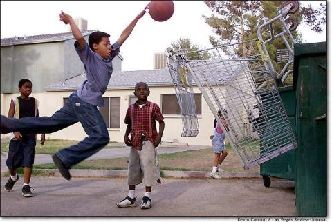 1991 Ford Crown Victoria LTD - Children play basketball in a residential area with a dumpster and shopping carts.
