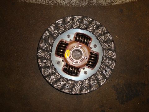 2002 Subaru Impreza - This is a close-up of a car's wheel hub, showing the intricate design of the brake rotor and the central emblem.