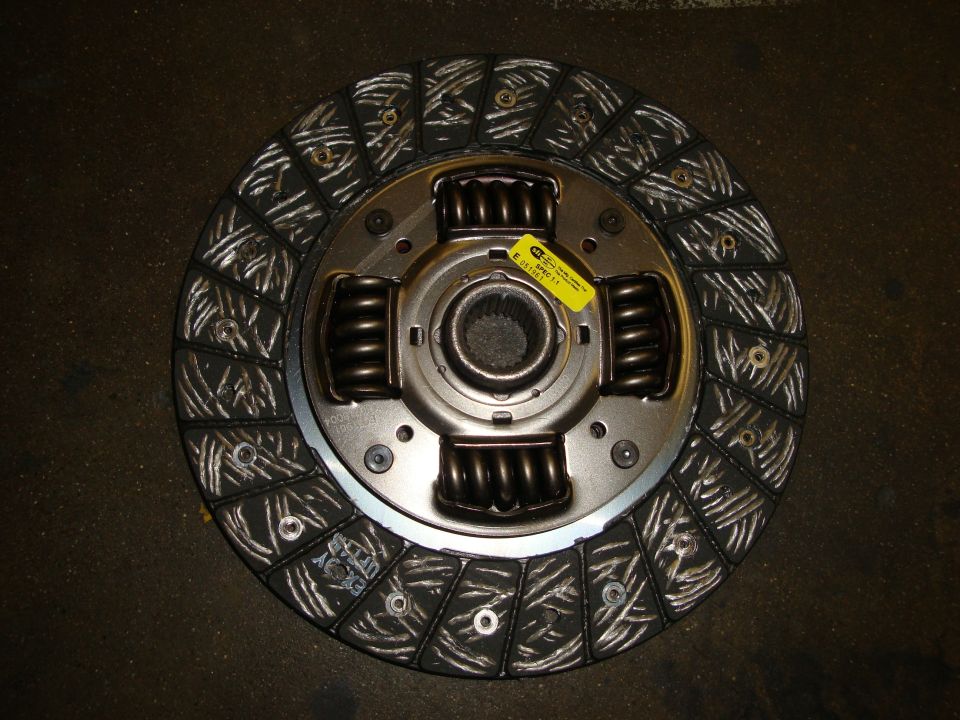 Close-up of a silver alloy wheel with a hexagonal center nut and colorful accents