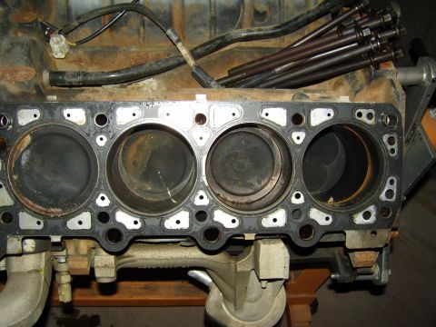 2007 Ford Mustang - Photograph of a stripped engine block showing four cylinder bores and head gasket.