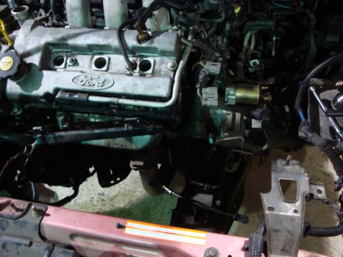 1994 Ford Probe - Getting the motor out. Radiator is removed, along with the distibutor and air box.