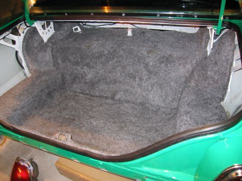 1991 Ford LTD Crown Victoria - Photograph of a classic sedan's carpeted trunk compartment, not a technical document.