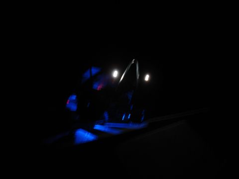 1996 Ford Bronco - A blurry, dark photo shows the side of a vehicle with blue and red lights reflecting on the ground. The vehicle appears to be a large SUV w…