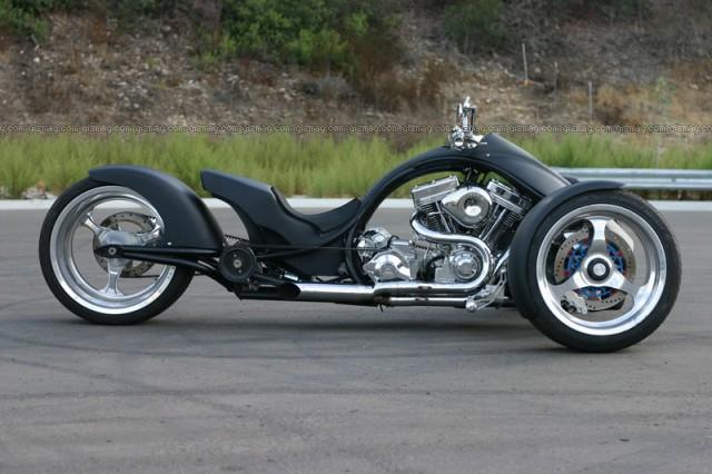 Low-slung matte-black custom V-twin motorcycle with polished billet wheels, side view, gizmag.com watermark