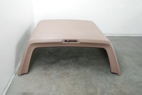 1996 Ford Bronco - Photograph of a tan fiberglass truck topper viewed from above, not a technical document.