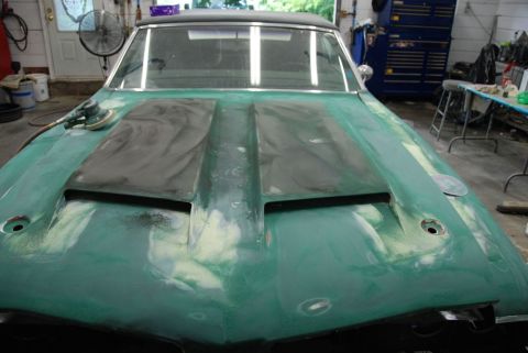 1996 Ford Bronco - Photograph of a classic car hood in primer during bodywork, not a technical document.