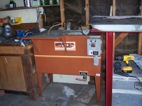 1991 Ford Bronco - Photograph of a parts washer machine in a garage, not a technical document.