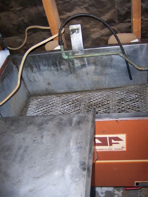 1991 Ford Bronco - Photograph of the inside of a parts washer tank, not a technical document.