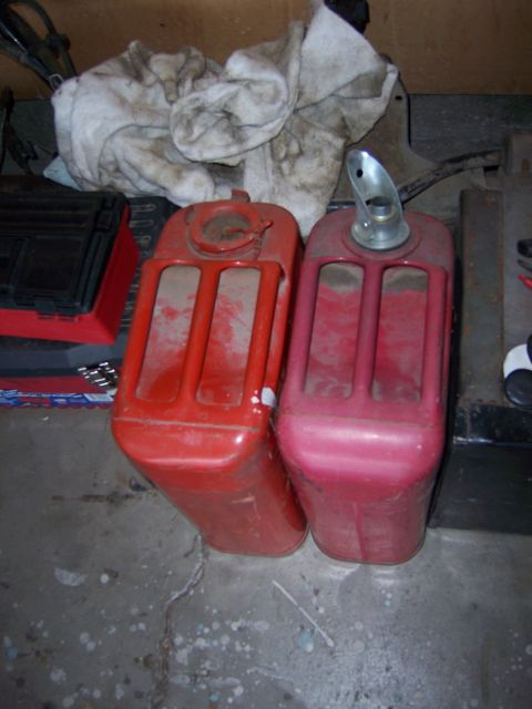 1991 Ford Bronco - Photograph of fuel cans on a garage floor, not a technical document.