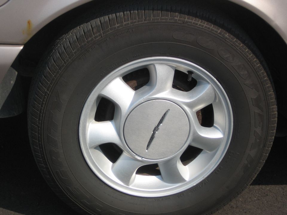 Close-up of a 1995 Ford Thunderbird wheel and tire.