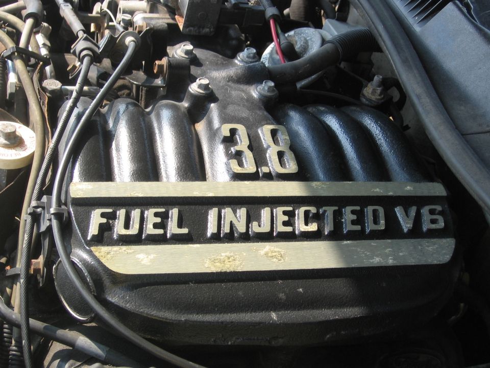 Close-up of a black 3.8L fuel injected V6 engine intake manifold