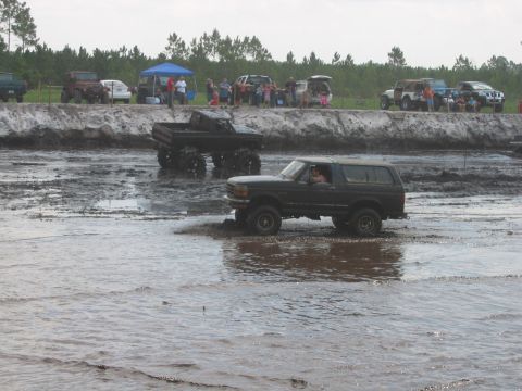 1992 Ford Bronco - Mud bogging event with multiple vehicles, including a 1992 Ford Bronco.