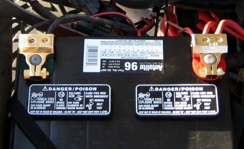 1996 Ford Bronco - Car battery with 'Autolite 96 Platinum' label and safety warnings visible.