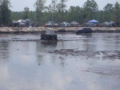 1989 Ford Bronco - A 1989 Ford Bronco navigates a muddy track during an off-road event.