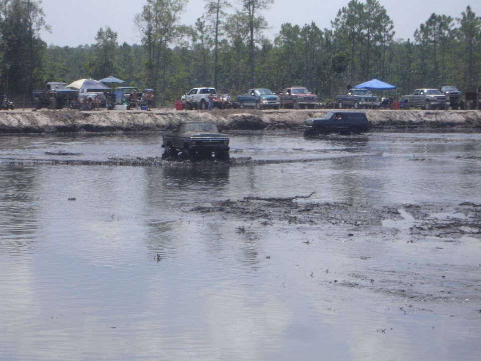 1989 Ford Bronco driving through mud