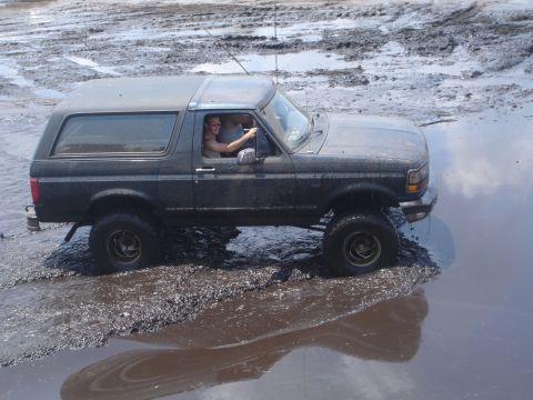 1989 Ford Bronco - 1989 Ford Bronco navigating a muddy off-road course.