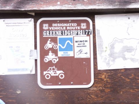 1986 Ford Bronco - A sign indicates a designated vehicle route with icons for different types of vehicles and a note about winches.