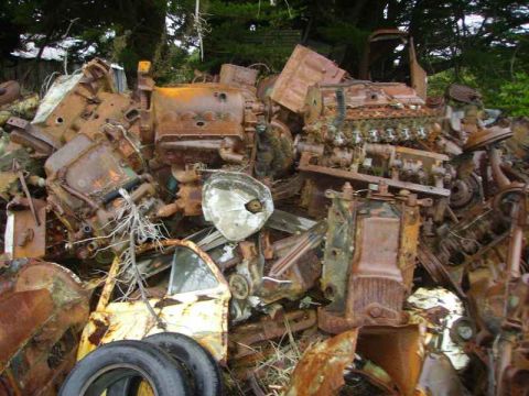 1969 MINI Cooper - A jumbled heap of decaying automotive components suggests a scrapyard or junkyard.