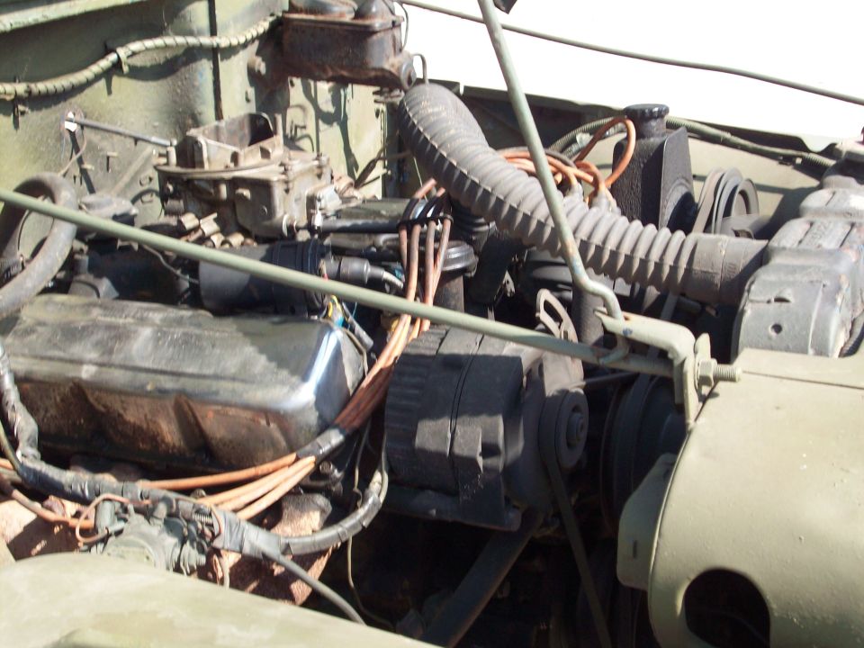 1978 Jeep CJ5 V8 engine bay with carburetor, alternator, and radiator hoses.