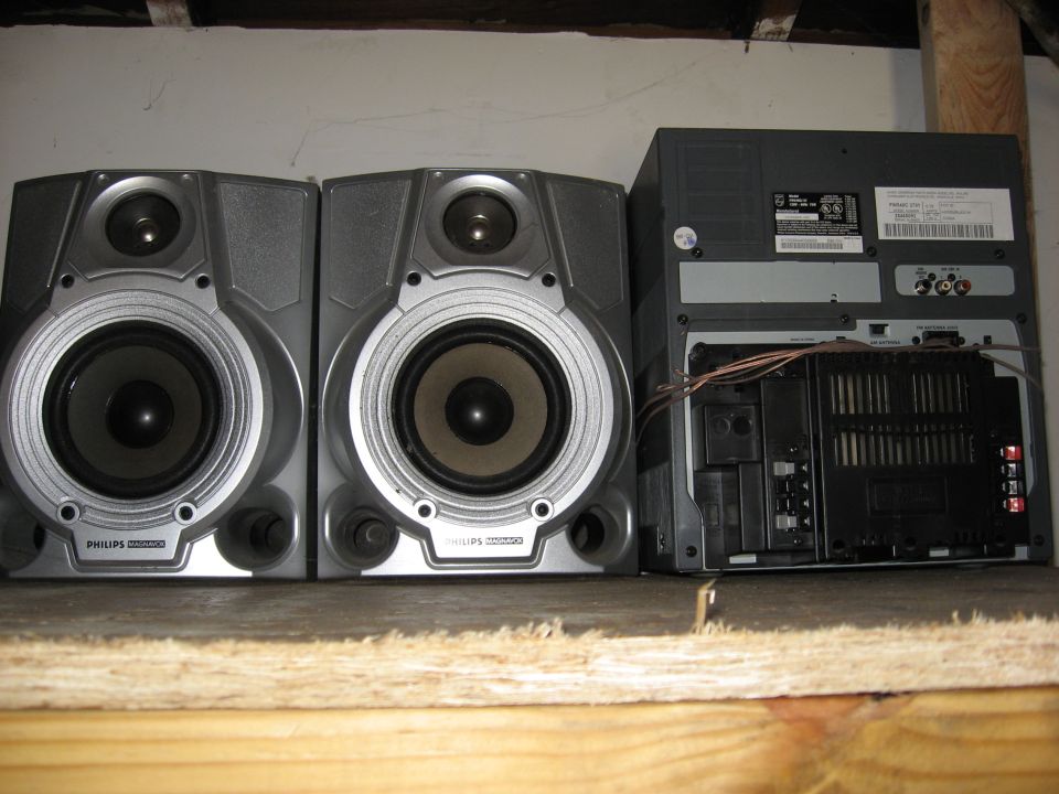 Pair of Philips bookshelf speakers and a stereo receiver on a shelf