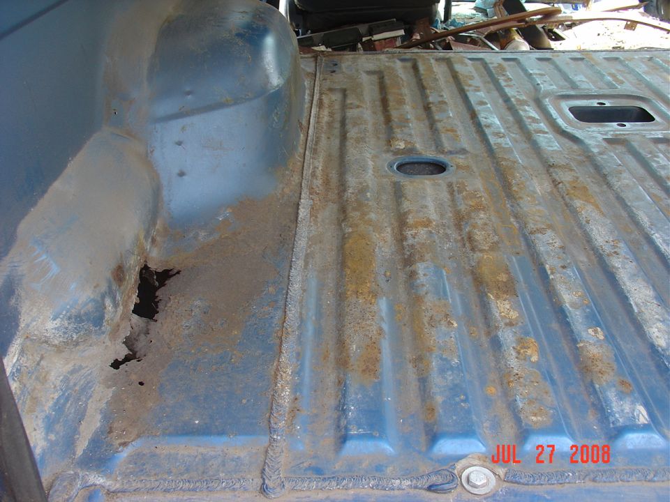 Close up of the rust hole on the rear driver side.