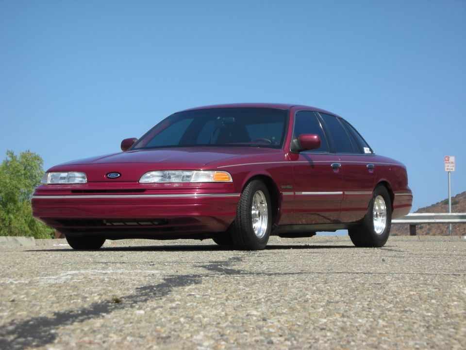 Maroon 1992 Ford Crown Victoria with a lowered stance, parked outdoors.