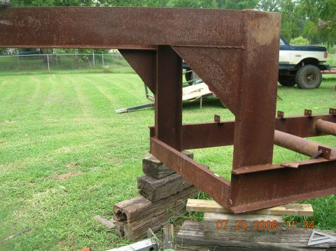 1991 Ford F-150 - A rusty metal structure is in the foreground, with a white vehicle in the background.