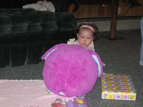 2000 Ford Crown Victoria - A baby sits on the floor behind a large stuffed toy, with gifts nearby.