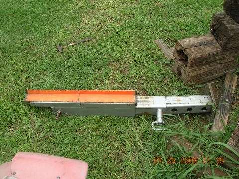 1991 Ford F-150 - Gooseneck trailer hitch extension part shown on grass with wooden beams nearby.