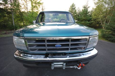 1996 Ford Bronco - Photograph of the front grille of a green Ford truck with a winch, not a technical document.