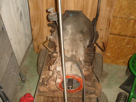 1989 Ford Bronco - A rusty transmission and differential assembly is shown mounted on a makeshift cart with small wheels. The assembly appears to be from a tr…