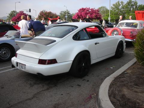 1998 Ford Crown Victoria - Photograph of a white Porsche 911 (964) with a rear wing parked at an outdoor car meet.