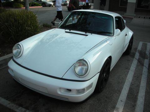 1998 Ford Crown Victoria - Photograph of a white Porsche 911 (964) parked along a curb.