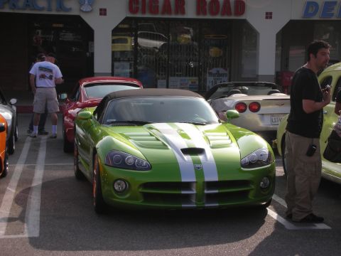 1998 Ford Crown Victoria - Photograph of a green Dodge Viper with white racing stripes parked at an outdoor car show.