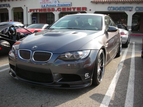 1998 Ford Crown Victoria - Photograph of a gray BMW M3 coupe parked outside a fitness center, not a technical document.