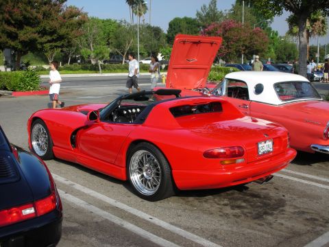 1998 Ford Crown Victoria - Photograph of a red Dodge Viper roadster parked at an outdoor car meet, not a technical document.