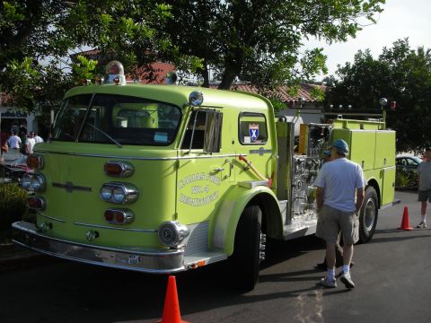 1998 Ford Crown Victoria - Photograph of a lime-green vintage American LaFrance fire engine on display, not a technical document.
