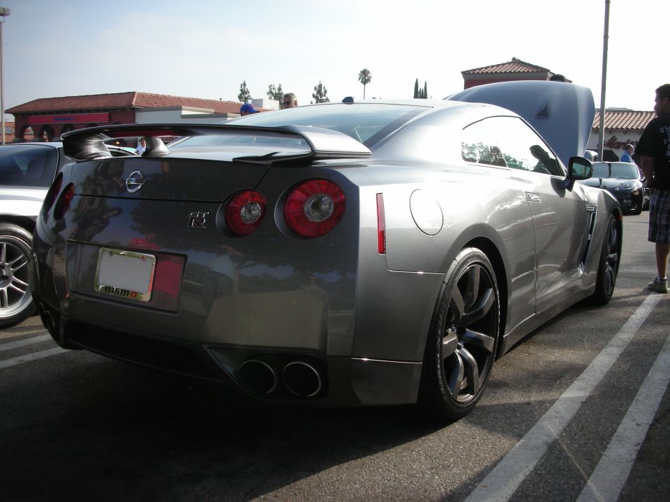 Rear three-quarter view of a gray Nissan GT-R at a car show