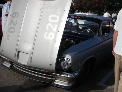 1998 Ford Crown Victoria - Photograph of a silver custom car with hood up and 620 HP markings, not a technical document.