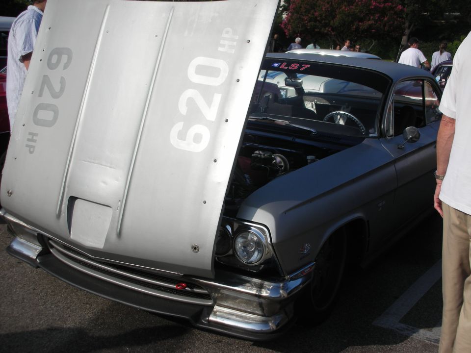Front of a silver custom car with hood raised showing '620 HP' text